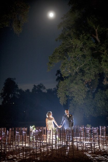 After the ceremony, a bride and groom are under the moonlight and oak trees in Murrieta, California.