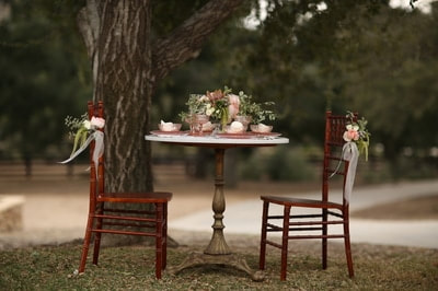 Private venue sweetheart table set with pink depression glass dishes.
