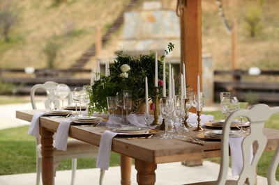 Farm table set at private venue for events.