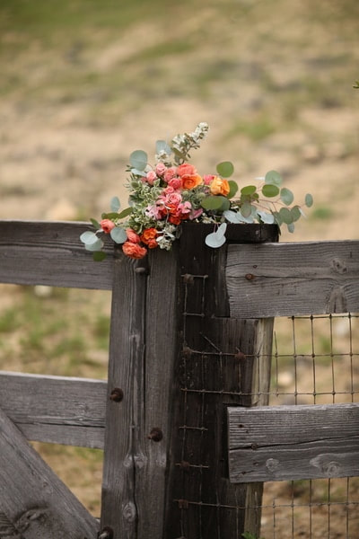 Flowers on a fence post at a private venue for events.