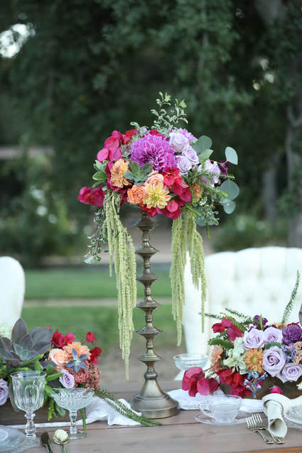 Floral centerpiece on a tall brass candlestick provides the perfect ambiance for an intimate wedding.