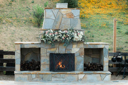 Outdoor stone fireplace is a perfect wedding spot for intimate weddings.