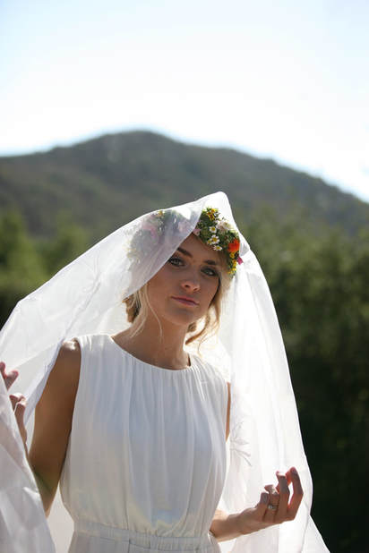 Bride with floral wreath and veil at the perfect wedding spot.
