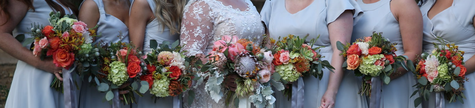 Beautiful bouquets being held by a bride and her six bridesmaids.  Private venue location.